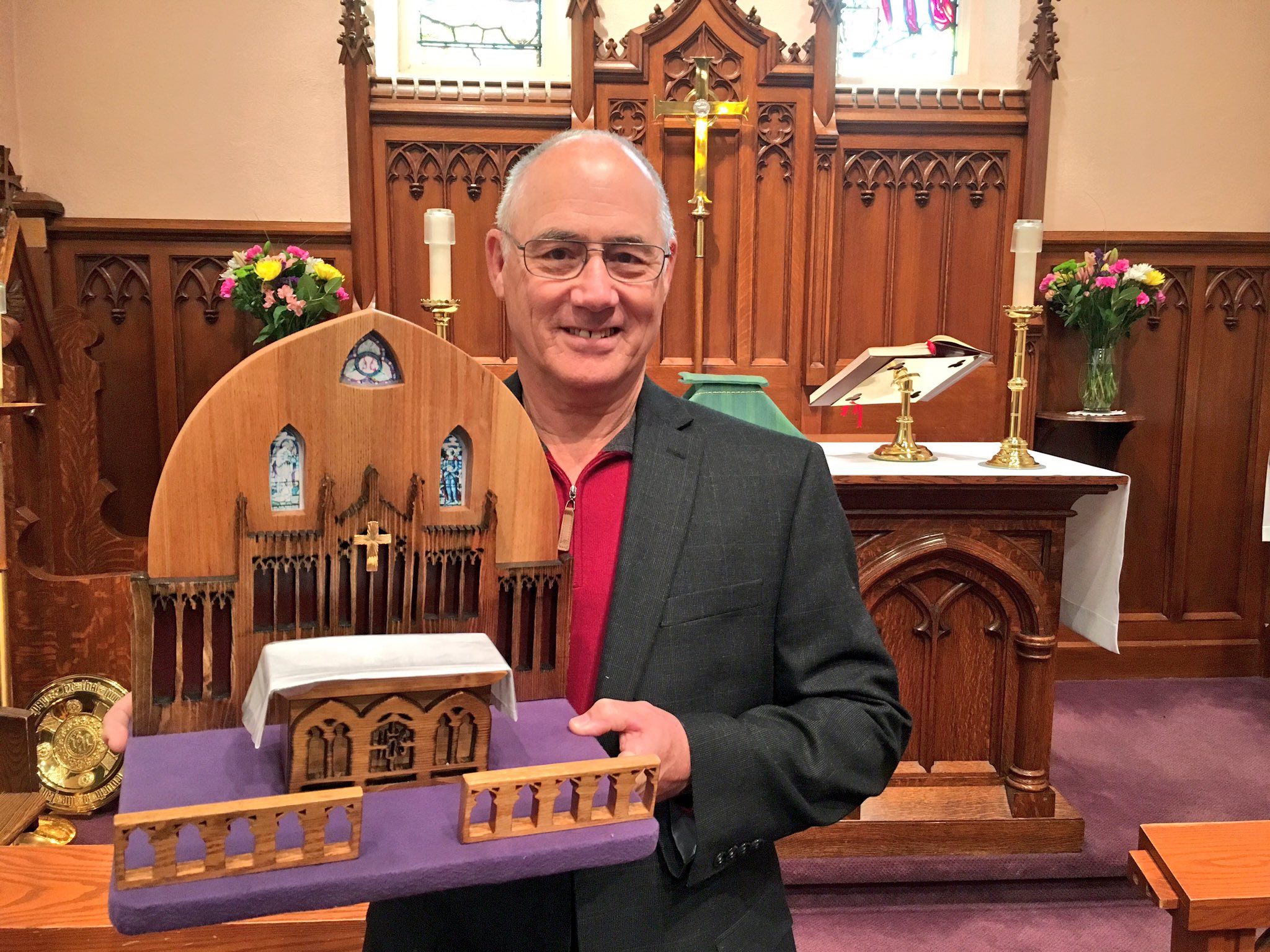 John Reaume holds the model of the sanctuary of St. George’s Georgetown, which he carved from an old wooden pew. Photo: Rob Park