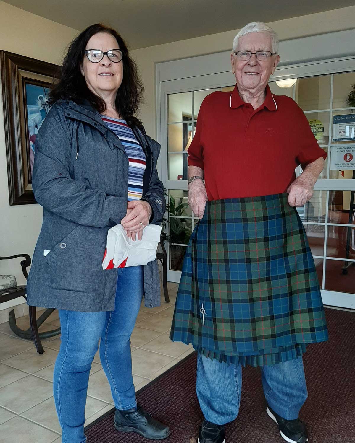 Beryl Holtam stands with David Wilson at Guelph Lake Commons as he models his newly repaired kilt. Photo: the Reverend Alan Cook