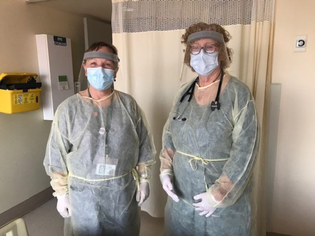 Ann (left) and colleague and fellow parishioner Dr. Bev Hattersley pose in their pandemic wardrobe.