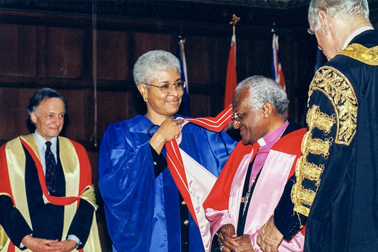 In February 2000, Desmond Tutu came to Toronto to receive an honorary Doctor of Laws from U of T, as well as an honorary doctorate of divinity from Trinity College. Here Tutu is hooded by Mary Anne Chambers, vice-chair of Governing Council, as University Professor John Polanyi, left, and Chancellor Hal Jackman, right, look on. (Photo: Lisa Sakulensky/University of Toronto Archives)