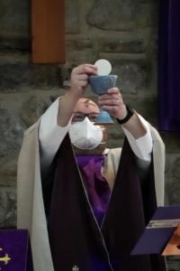 Canon Matthew Griffin celebrates the Eucharist at Church of the Nativity, Hamilton.