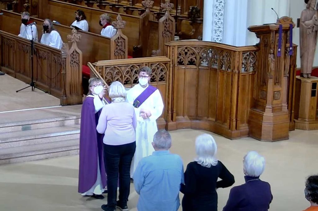 Bishop Susan Bell offers the imposition of ashes at Christ's Church Cathedral.