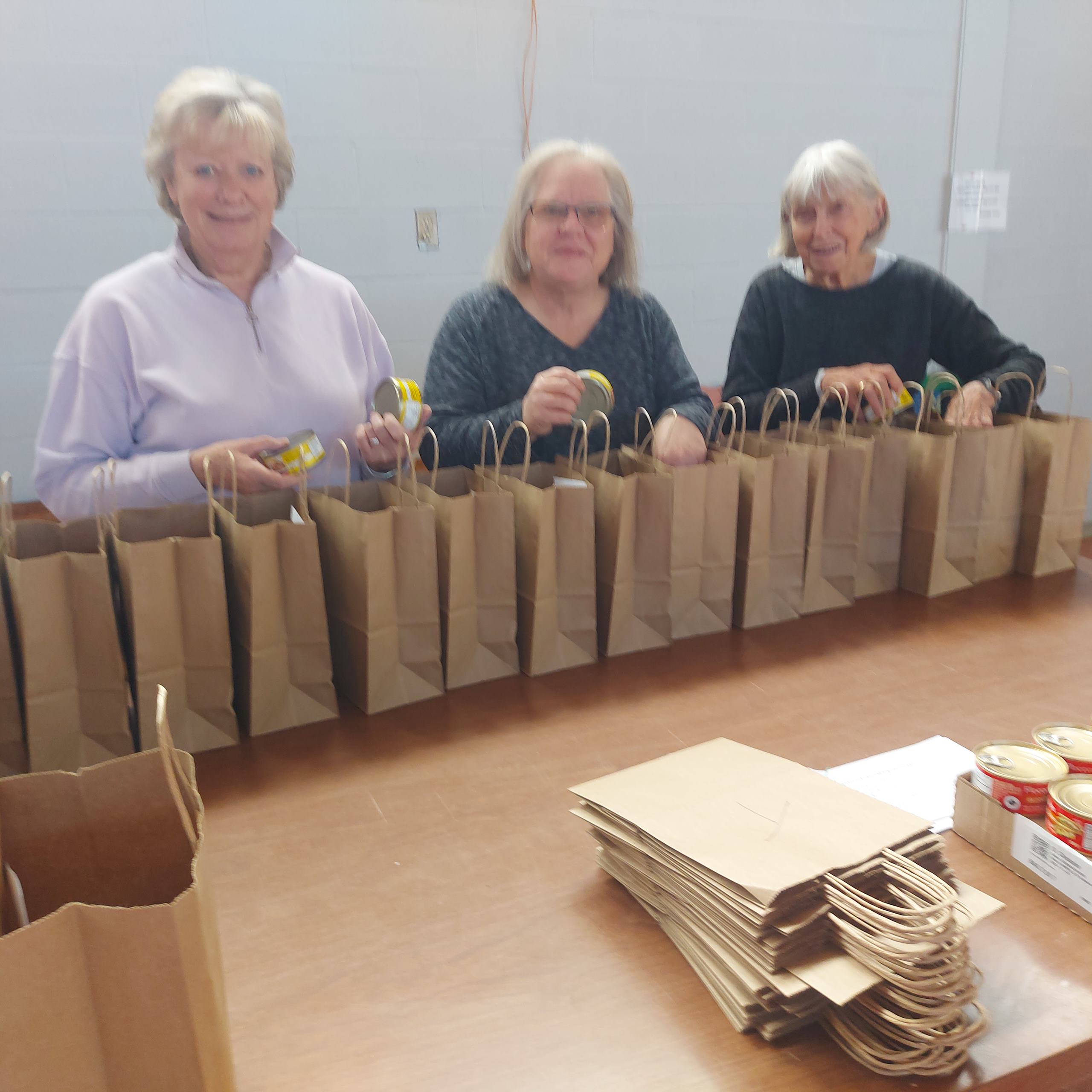 Volunteers assemble the meal kits.